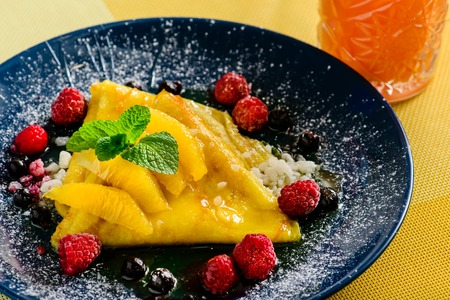 Sweet delicious pancake blinis with curd, jam and berries. New restaurant menu for the holiday Maslenitsaの写真素材