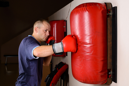 Close up shot of a boxer improving his skills working on punching bag. Unstoppableの写真素材