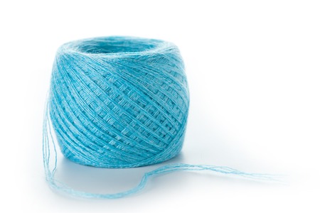 Ball of blue wool yarn isolated on whiteの写真素材