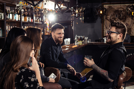 Cocktail bars, cheerful company of friends celebrates February 6th Bartender's Day Minsk, toned, Belarus, 2019のeditorial素材