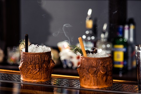 cocktail bar, alcoholic cocktail at bar counter in nightclub close-up, shallow dof, tonedの写真素材