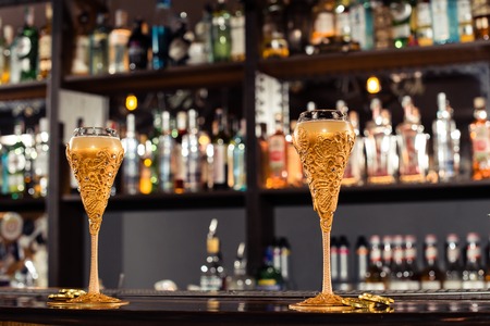 cocktail bar, alcoholic cocktail at bar counter in nightclub close-up, shallow dof, tonedの写真素材