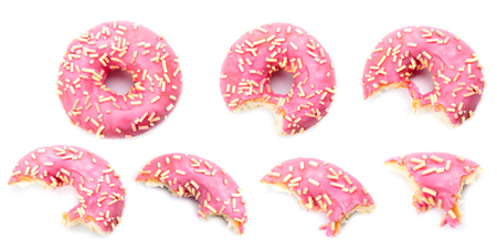 seven stages of pink donut biting on white background. Delicious Donut with Bite Missing Isolatedの写真素材