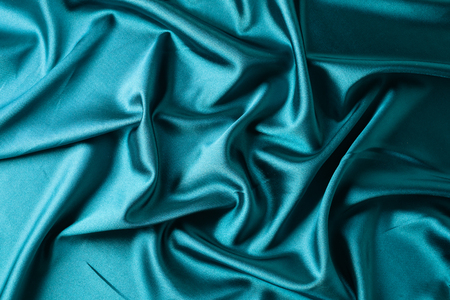 abstract green background texture shiny fabric silk with copy spaceの写真素材