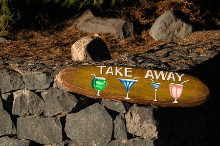 cocktails wooden sign in a street bar. Pointing marker. Wooden sign arrow in cafe.の写真素材