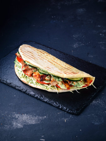 turkish fast food - chicken in pita bread, Doner kebab - fried chicken meat with vegetables in pita...