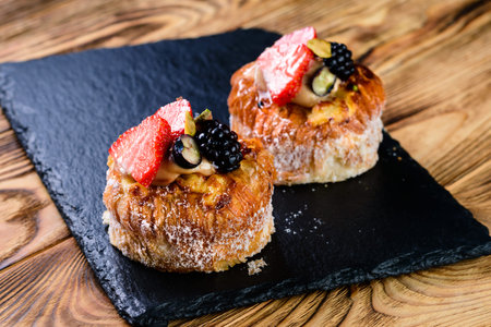 delicious Mini dessert tart sweet pastries, shortcake pies on rustic wooden table tart with fresh...