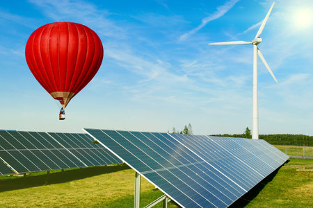 hot air balloon red over Solar energy panel and wind turbine farm power generator production of...