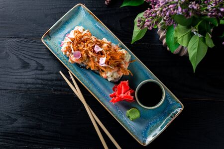 Hot fried Tempura Sushi Roll serving on a dark tablehot sushi rolls serving on a dark table. Japanese food top view, flat layの写真素材