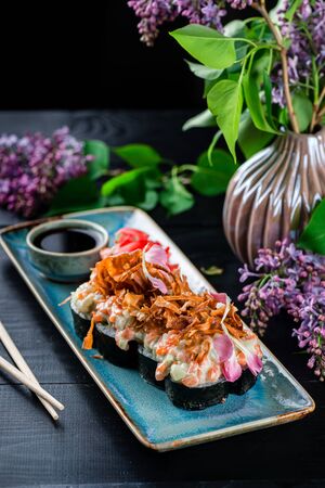 Hot fried Tempura Sushi Roll serving on a dark tablehot sushi rolls serving on a dark table. Japanese food.の写真素材