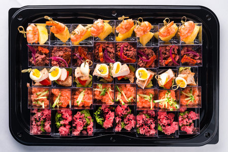 seafood appetizers for a buffet, Canapes of cheese vegetables meat and seafood top view, flat lay