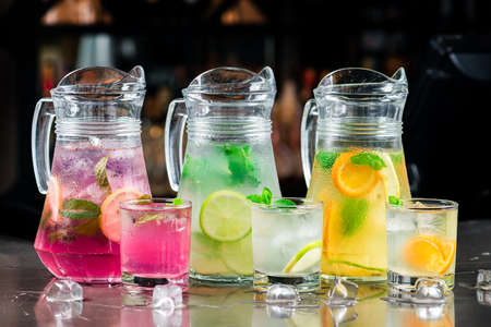 Lemonade set. Lemonade, mojito and orange lemonade. Iced summer drink in mason jar with ingredients. set of summer lemonadesの写真素材