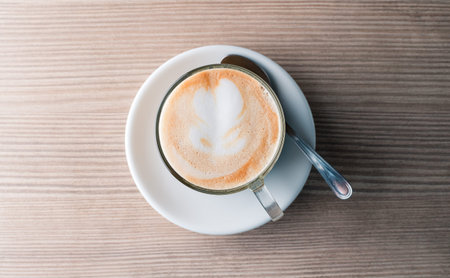 latte on a wood table, coffee cappuccino with a pattern