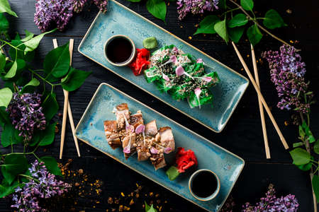 Sushi rolls - Kyoto with salmon and Chuka salad. Sushi menu bar. Japanese food Sushi served top view, flat layの写真素材
