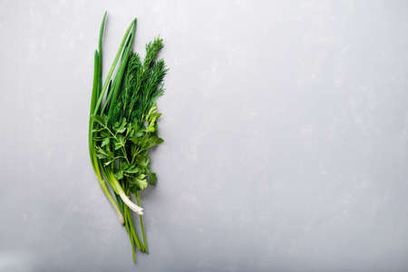 bunch of fresh herbs onions parsley and dill on an empty background. Fresh garden herbs Top view with copy spaceの写真素材