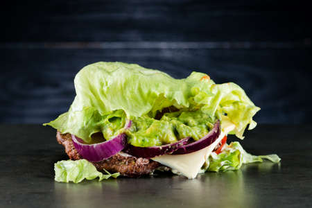 Juicy low-carb Burger with guacamole, close-up shot keto paleo diet avocado burgerの写真素材