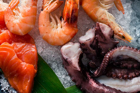 Octopus appetizer food concept on black table. octopus in a set of seafood close up food background. Octopus with salt and herbの写真素材