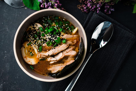 Asian traditional soup with meat. Asian cuisine, Vietnamese pho bo soup in a plate on a dark top...