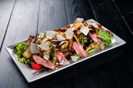 beef meat burger with cheese and green salad on a black background, big expensive Burgerの写真素材