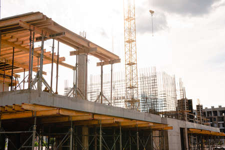 Modern construction site with scaffolding, housing construction frame concreteの写真素材