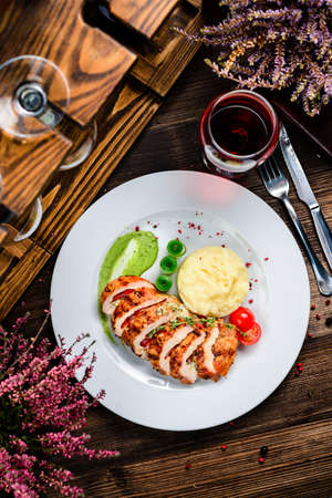 Slices of roasted chicken breast, chicken breast and mashed potato top view, flat layの写真素材