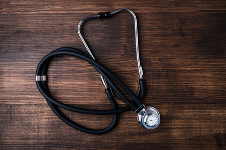 Stethoscope in doctors desk, medical stethoscope on wooden table