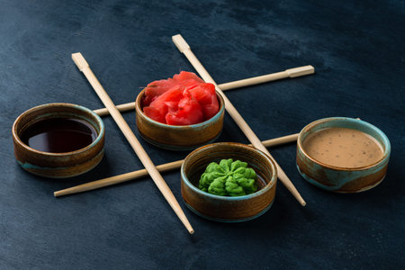 Set for sushi soy sauce ginger wasabi with chopstick on black background, soy sauce, wasabi and...