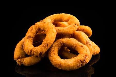 Deep fried calamari rings isolated on black, squid rings friesの写真素材