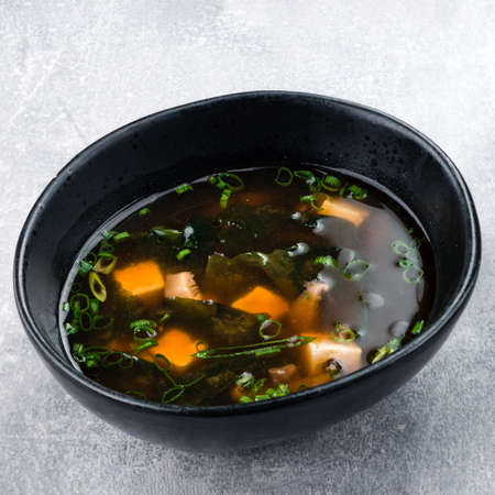 Japanese miso soup with tofu on the table. top view of Miso soup with shiitake mushrooms and seaweedの写真素材