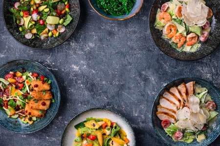 Asian salads with copy space in center. Menu, cuisine, kitchen concept. Asian food served, top view, space for text. Chinese and vietnamese cuisine set.の写真素材