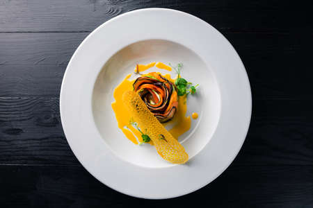 Vegetable ratatouille baked preparation recipe healthy diet french vegetarian food on vintage wooden table background. Top viewの写真素材
