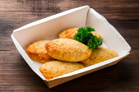 chicken cutlets with herbs on a dark wooden background, homemade chicken cutlets with Free copy space, takeaway foodの写真素材