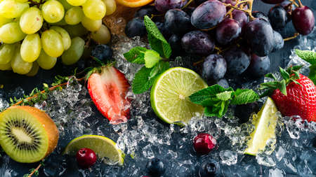 Fresh fruits background. Slices of fresh fruits on ice. fresh fruit and ice crash copy space abstract backgroundの写真素材