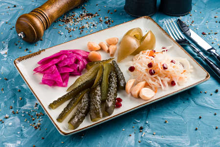 appetizers set pickles, cabbage and tomatoes on a plate, Fermented vegetables on plate sauerkraut, pickled cabbage, pickled cucumbers, marinade tomatoes. Vegetarian food conceptの写真素材