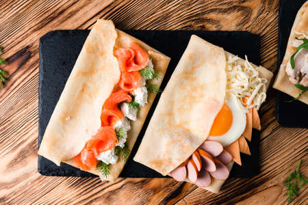 set of crepe with different fillings, pancakes with various fillings with beautiful presentation, top view, flat layの写真素材