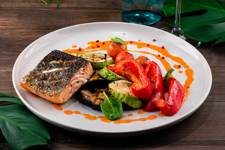 grilled salmon and grilled vegetables pepper, eggplant, zucchini, Hot and spicy fillet red fish. Grilled steak salmon or trout with grill paprika. Healthy food, seafood and vegetables.の写真素材