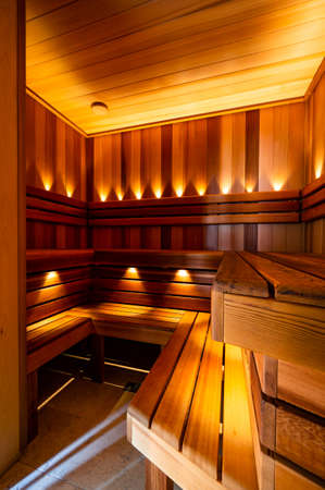 The Red Canadian Cedar Finnish Sauna interior with lightsの写真素材