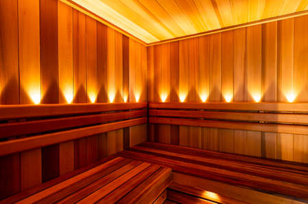 The Red Canadian Cedar Finnish Sauna interior with lightsの写真素材