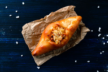 russian pie rasstegay with a hole on top, Traditional Russian, Slavic pies with hole in center. Rasstegay on wooden backgroundの写真素材