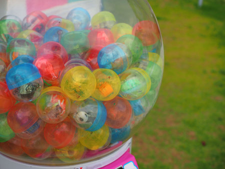 small toy in colorful ball in kid game vendor machine