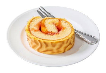 Close up roll cake served on white dish with fork isolated on white - deep focus photoの写真素材
