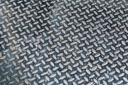 Close up grunge black color diamond metal plate texture backgroundの写真素材