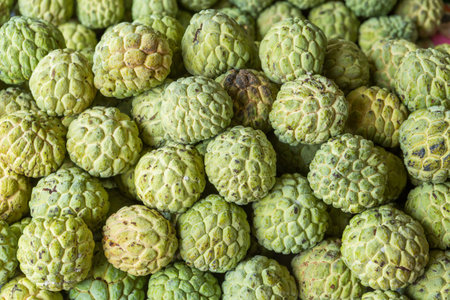 Close up sugar apple piles in market