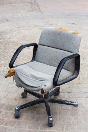 Old ans ruin executive chair with wheels on concrete, time to change new one conceptの写真素材