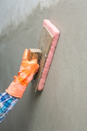 Concrete plaster cleaning by sponge in construction siteの写真素材