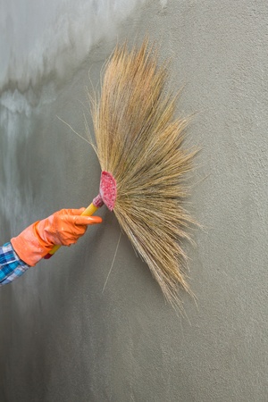 Concrete plaster cleaning by broom in construction siteの写真素材