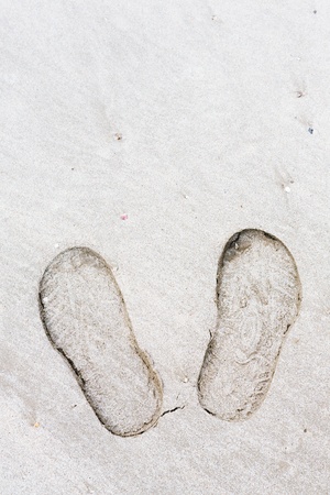 Close up shoe prints in the beachの写真素材
