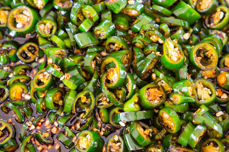 Close up Green chili sliced in black soy sauceの写真素材