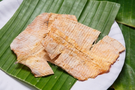 Close up Grilled dry squid on banana leaf in paper dishの写真素材