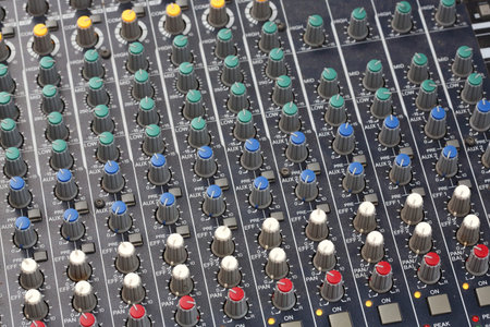 Close up multi color buttons of sound mixer console